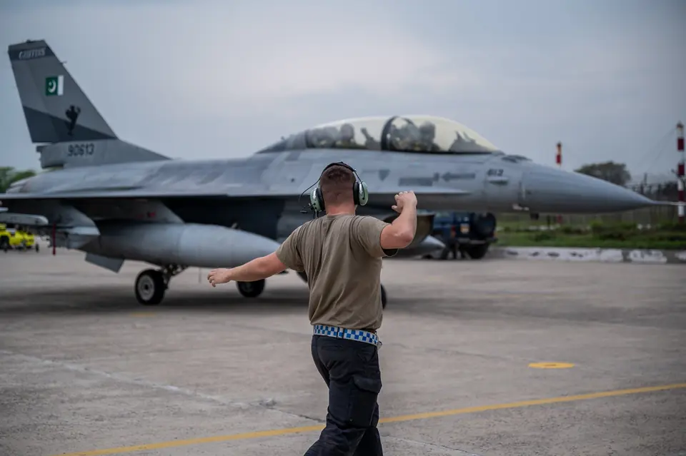 A US Air Force crew chief marshals a Pakistan Air Force F-16 during joint training in Pakistan, 2 March 2022: the fighter first sold to Pakistan in the 1981 package