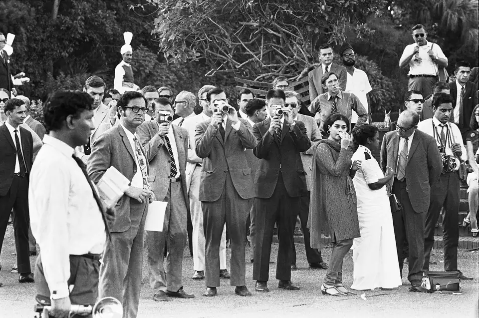 Observers and photographers at the arrival ceremony for President Nixon in Pakistan, among them H. R. Haldeman filming with his own cine camera, 1 August 1969