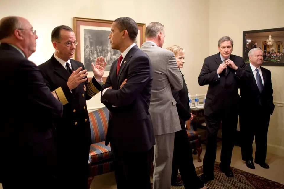 President Barack Obama talks with Admiral Michael Mullen, Chairman of the Joint Chiefs of Staff, and other officials before his speech on strategy for Afghanistan and Pakistan, 27 March 2009