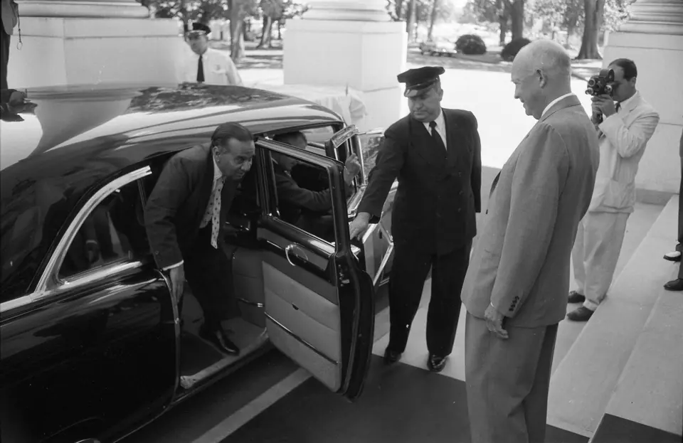 President Eisenhower greets Prime Minister Huseyn Shaheed Suhrawardy of Pakistan as he gets out of a car at the White House, 10 July 1957